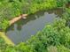 A beautiful serene neighborhood pond with dock access, surrounded by mature greenery at 6460 Valley Crossing Way, Cumming, GA 30028