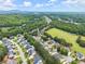 Aerial view of neighborhood showcasing tree-lined streets and well-maintained lawns at 6460 Valley Crossing Way, Cumming, GA 30028