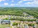 A neighborhood with homes nestled among the trees from an aerial view at 6460 Valley Crossing Way, Cumming, GA 30028