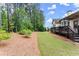 Relaxing backyard showcasing a well-maintained lawn, mulch beds and the wooden deck at 6460 Valley Crossing Way, Cumming, GA 30028