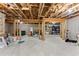 Unfinished basement with exposed wood framework provides opportunity for customization at 6460 Valley Crossing Way, Cumming, GA 30028