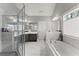 Bright bathroom features a soaking tub and glass enclosed shower at 6460 Valley Crossing Way, Cumming, GA 30028