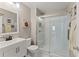 Bright bathroom features a sleek glass shower, modern vanity, and stylish fixtures at 6460 Valley Crossing Way, Cumming, GA 30028