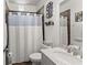 Bathroom with a white shower curtain, toilet, vanity and decorative accents at 6460 Valley Crossing Way, Cumming, GA 30028
