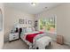 Cozy bedroom featuring a window for natural light and comfortable furnishings at 6460 Valley Crossing Way, Cumming, GA 30028
