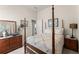 Comfortable bedroom with wood furnishings and warm natural light at 6460 Valley Crossing Way, Cumming, GA 30028