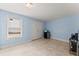Light blue bedroom with window, closet, and mini fridge at 6460 Valley Crossing Way, Cumming, GA 30028