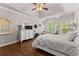 Spacious bedroom with hardwood floors, tray ceiling, and natural light at 6460 Valley Crossing Way, Cumming, GA 30028