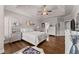 Bright bedroom featuring a tray ceiling and hardwood floors at 6460 Valley Crossing Way, Cumming, GA 30028