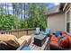 Inviting outdoor deck with stylish seating arrangement, lush landscaping, and privacy at 6460 Valley Crossing Way, Cumming, GA 30028