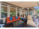 Covered outdoor deck features comfortable seating, a ceiling fan, and view of the backyard at 6460 Valley Crossing Way, Cumming, GA 30028