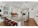 Gourmet kitchen features granite counters, an island, stainless appliances, and breakfast bar seating at 6460 Valley Crossing Way, Cumming, GA 30028