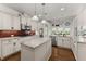Gourmet kitchen with white cabinets, granite countertops, stainless appliances and center island at 6460 Valley Crossing Way, Cumming, GA 30028