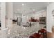 Open kitchen with granite counters, stainless appliances, bar seating and views to breakfast area at 6460 Valley Crossing Way, Cumming, GA 30028