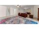 Cozy living room featuring neutral walls, tile floors, ceiling fans, and a comfortable leather sofa set at 6460 Valley Crossing Way, Cumming, GA 30028