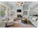 Comfortable living room features a fireplace, built-in shelves, and coffered ceilings at 6460 Valley Crossing Way, Cumming, GA 30028
