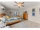 Comfortable main bedroom featuring a ceiling fan, tile flooring, and tasteful decor at 6460 Valley Crossing Way, Cumming, GA 30028