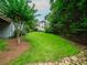 Picturesque backyard with mature trees, lush lawn, and a home's exterior at 740 Orchard Ct, Atlanta, GA 30328