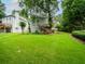 Expansive backyard featuring a well-kept lawn and attractive landscaping, including mature trees at 740 Orchard Ct, Atlanta, GA 30328