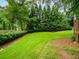 Well-manicured backyard with defined landscaping and lush green lawn at 740 Orchard Ct, Atlanta, GA 30328