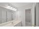 Bright bathroom featuring a large mirror, white vanity, and a separate room for the shower and toilet at 740 Orchard Ct, Atlanta, GA 30328