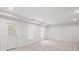 Open bedroom with neutral carpet, recessed lights, and a glass patio door at 740 Orchard Ct, Atlanta, GA 30328