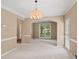 Spacious dining room featuring a chandelier and large window for natural light at 740 Orchard Ct, Atlanta, GA 30328