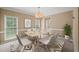 Elegant dining area with modern table, chairs, rug and natural light at 740 Orchard Ct, Atlanta, GA 30328
