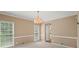 Neutral toned dining room with windows on two walls and light wood floors at 740 Orchard Ct, Atlanta, GA 30328