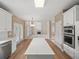 Open concept kitchen with white island, view to living room and access to double doors at 740 Orchard Ct, Atlanta, GA 30328