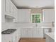 Elegant kitchen showcasing white cabinetry, quartz countertops, and stainless steel appliances at 740 Orchard Ct, Atlanta, GA 30328