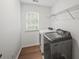 Laundry room with washer, dryer, window, and wire shelf at 740 Orchard Ct, Atlanta, GA 30328