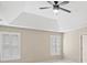 Bedroom featuring two windows with blinds, a ceiling fan, and tray ceiling at 740 Orchard Ct, Atlanta, GA 30328