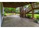Spacious covered patio featuring stairs to a wooden deck and an expansive lawn area at 740 Orchard Ct, Atlanta, GA 30328