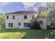 Expansive backyard featuring lush lawn, mature trees and a view of the back of the two story house at 1615 Burnt Oak Way, Dacula, GA 30019