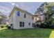Well-maintained backyard shows lawn, mature trees and the back of the two story home at 1615 Burnt Oak Way, Dacula, GA 30019