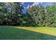 Picture of an expansive, lush backyard shows abundant green space and mature trees at 1615 Burnt Oak Way, Dacula, GA 30019