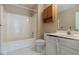 Bathroom with a bathtub and shower combo, toilet, sink, vanity, and white tile flooring at 1615 Burnt Oak Way, Dacula, GA 30019