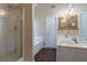 Bathroom features a glass shower, tub, double sinks, vanity, and modern fixtures at 1615 Burnt Oak Way, Dacula, GA 30019