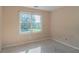Empty bedroom featuring a large window offering natural light at 1615 Burnt Oak Way, Dacula, GA 30019