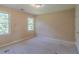 Bedroom featuring two windows, neutral walls, and overhead lighting, creating a bright and airy space at 1615 Burnt Oak Way, Dacula, GA 30019