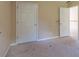 Bedroom featuring beige walls and doors, highlighting the room's simple architectural details at 1615 Burnt Oak Way, Dacula, GA 30019