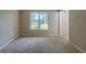 Neutral bedroom featuring a large window providing ample natural light at 1615 Burnt Oak Way, Dacula, GA 30019