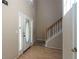 Bright foyer showcasing hardwood floors, staircase, and a glass-paneled front door at 1615 Burnt Oak Way, Dacula, GA 30019