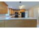 A functional kitchen featuring a breakfast bar, wood cabinets, and modern appliances at 1615 Burnt Oak Way, Dacula, GA 30019