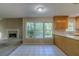 Eat-in kitchen with large windows, tile floors, and a view of living room with fireplace at 1615 Burnt Oak Way, Dacula, GA 30019