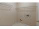 Functional laundry room features convenient shelving and essential hookups for efficient chore management at 1615 Burnt Oak Way, Dacula, GA 30019