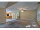 Open-concept room showcasing an integrated kitchen area, fan, and lots of natural light at 1615 Burnt Oak Way, Dacula, GA 30019