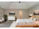 Virtually staged bedroom with contemporary furnishings, artwork, and a walk-in closet entrance at 1615 Burnt Oak Way, Dacula, GA 30019