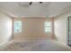Spacious primary bedroom with a tray ceiling, natural light, and ample space for furnishings at 1615 Burnt Oak Way, Dacula, GA 30019